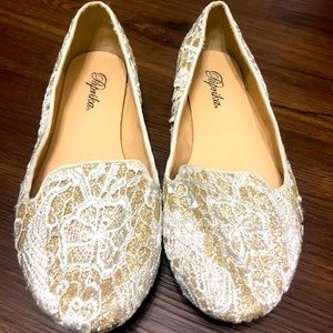 Gold and white flats. Worn a few times. No wear and tear.